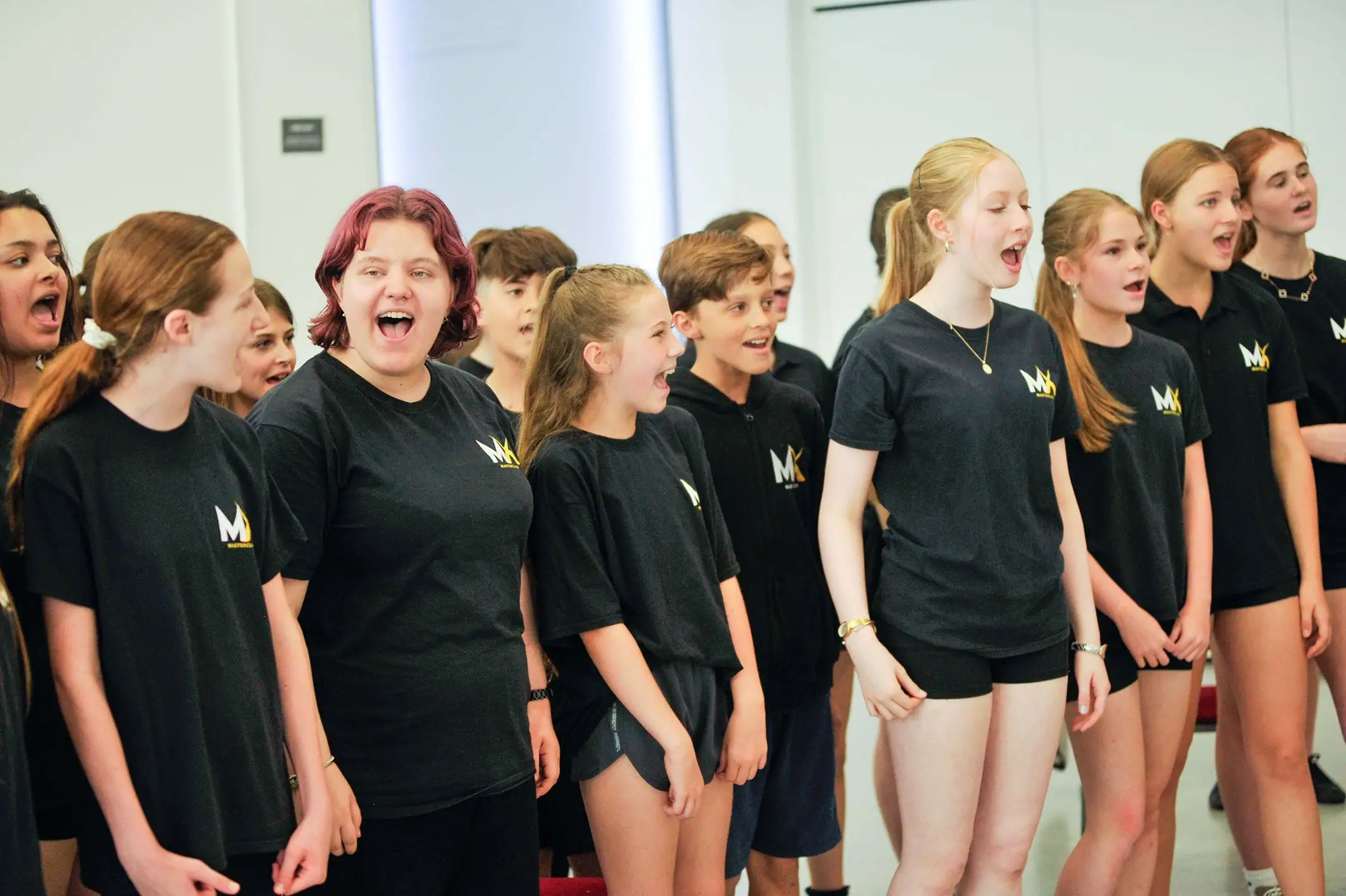 Teens laughing on the MX Musical Theatre course