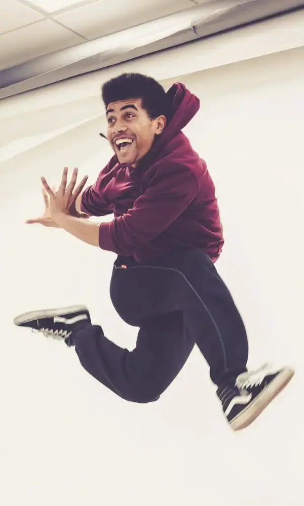 Student jumping and posing on the MXM course